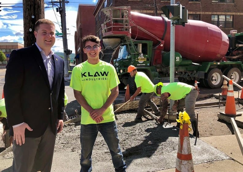 Kumpon with Mayor Kraham at a pour site in Binghamton, wearing a high visibility KLAW Industries t-shirt