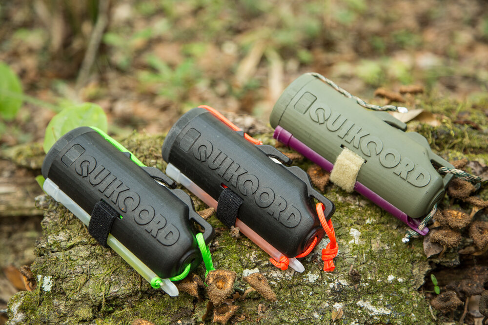 Three colorways of the Quikcord product on a mossy log