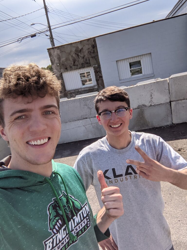 KLAW Industries founders Jack Lamuraglia and Jacob Kumpon accept a waste glass delivery