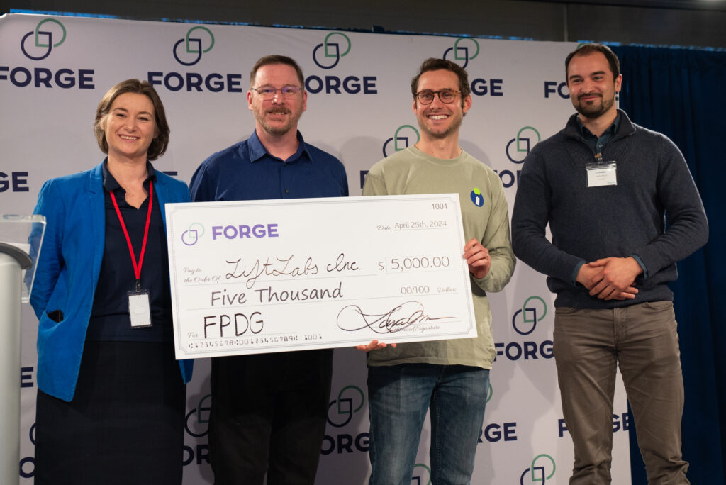 Laura Teicher poses with LiftLabs' cofounders and Jose LaSalle, contest judge and CEO/cof-founder of florrent, at the FORGE Spring Startup Showcase at the Dassault Systemes 3DEXPERIENCE Lab in Waltham, MA on Apr. 25, 2024.