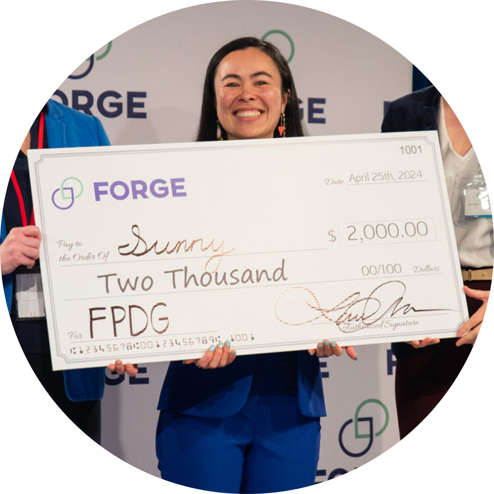 A startup founder winning a Product Development Grant after a FORGE pitch contest