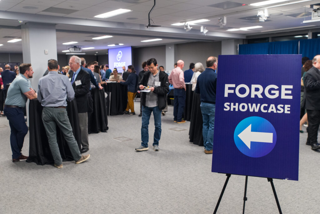 FORGE Fall Startup Showcase event sign and crowd