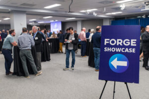 FORGE Fall Startup Showcase event sign and crowd