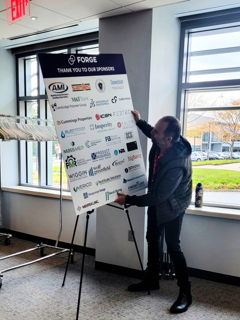 Adam Rodrigues setting up the FORGE partner sign